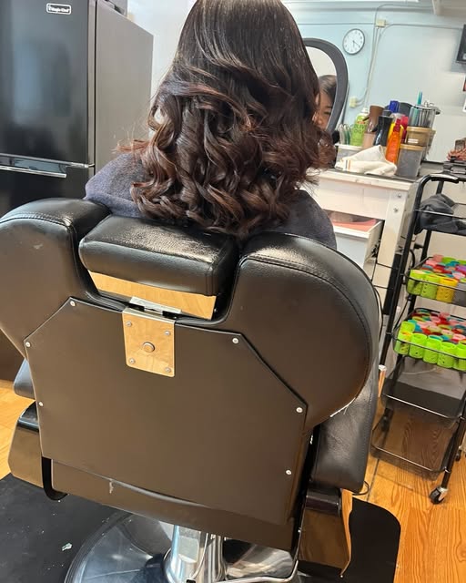 Finished curled hairstyle in salon chair